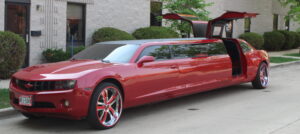 Red Camaro stretch limousine with custom doors for Milwaukee party and event transportation.