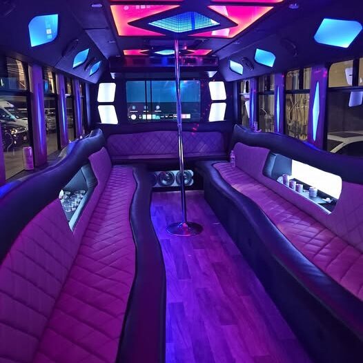 Milwaukee luxury party bus interior with LED lights, leather seating, and premium limo amenities by Churchill Luxurious Limousine Service.