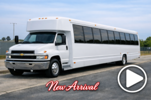 shuttle bus parked on a suburban road with tinted windows and chrome grille.