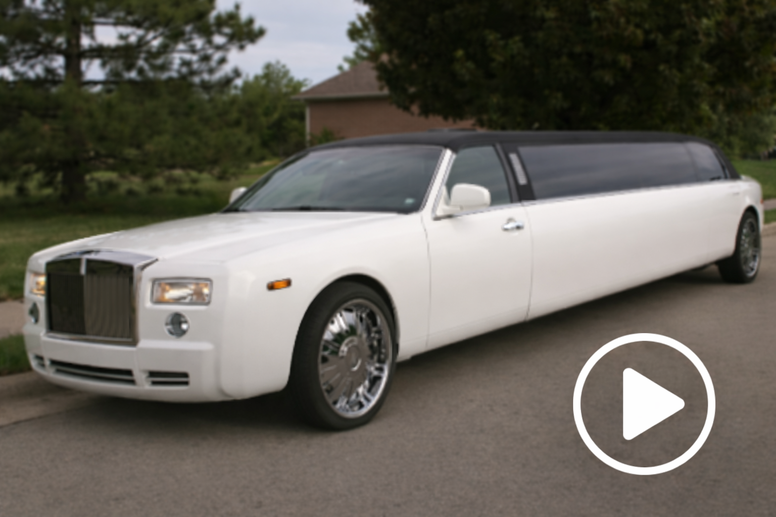 White stretch limousine parked in suburban Milwaukee, luxury transportation by Churchill Limousine.