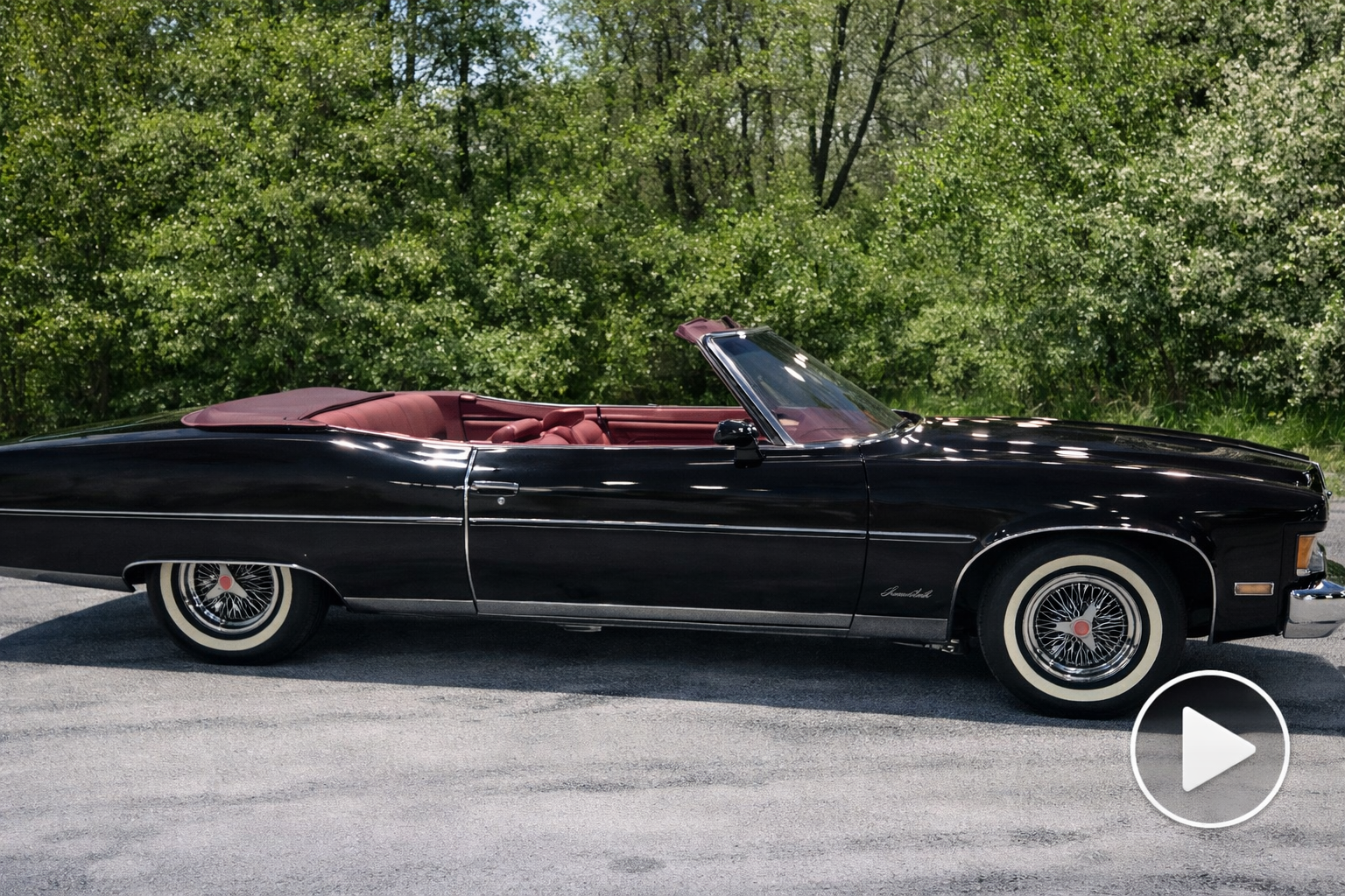 Vintage black convertible with chrome accents parked outdoors in Milwaukee